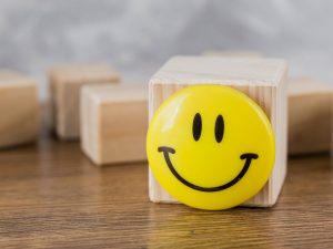 front-view-of-smiley-face-on-wooden-block
